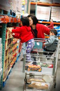 Mother pushing child around a supermarket