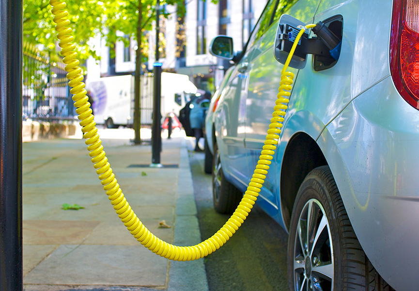An electric car at a charging point in a city centre