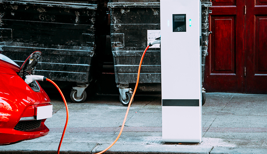 An electric car charging in a city centre