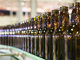 A line of glass bottles in a glass manufacturing plant