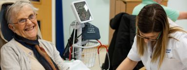 Nursing student examining a happy patient