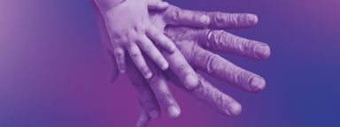 A child's hand, an adult's hand and an elderly person's hand laid on top of each other