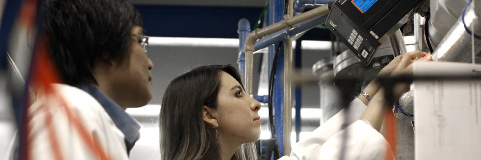 An image of two students working together in a lab