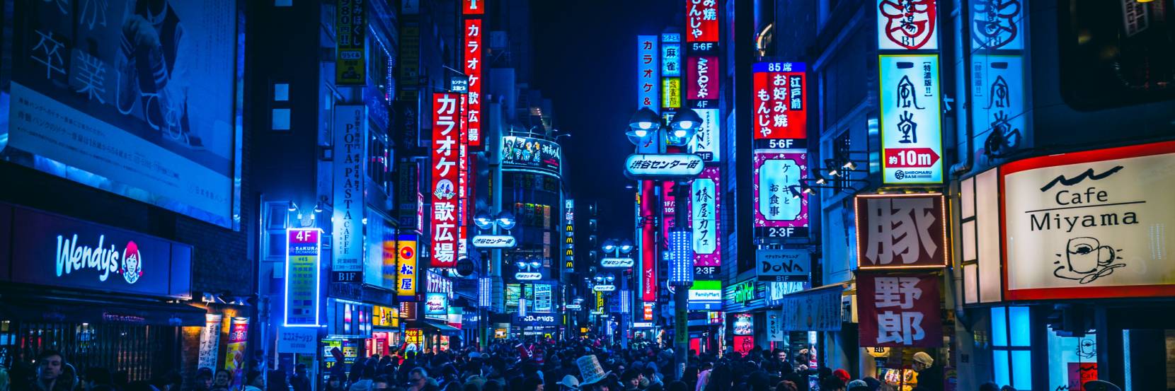 A crowded street in Tokyo at night