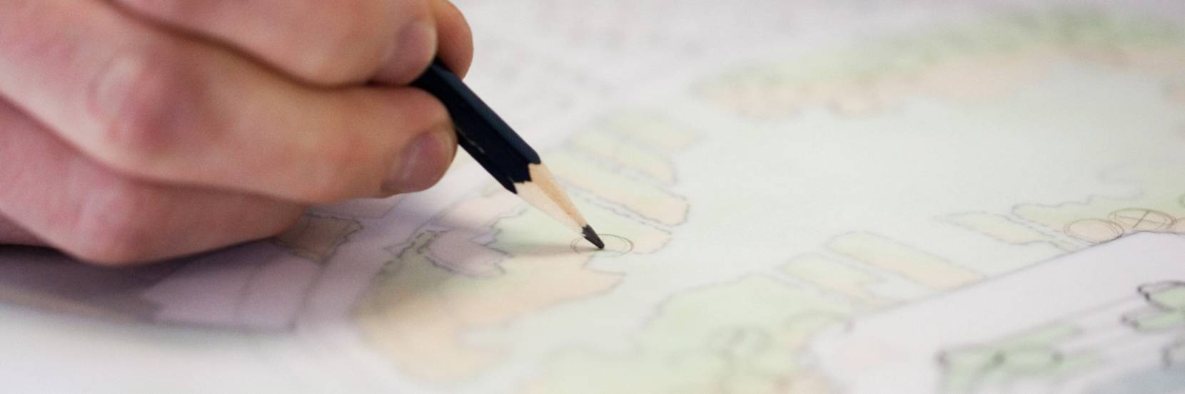 Hand sketching a plan in the studio