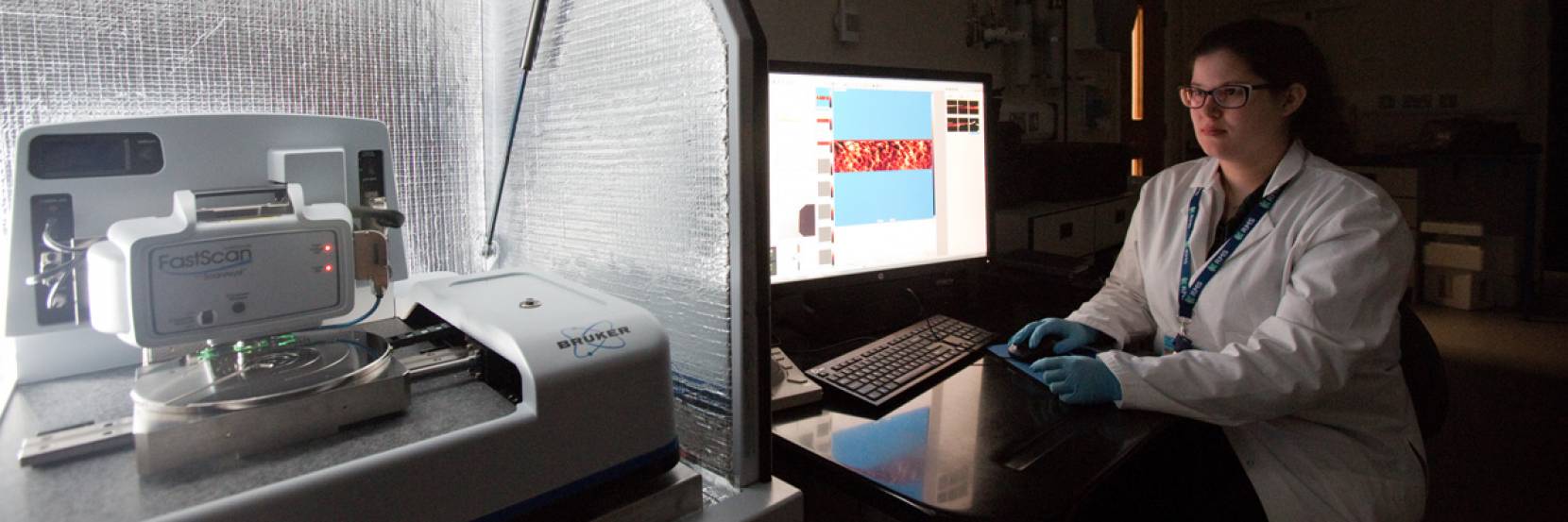 A student using an atomic force microscope