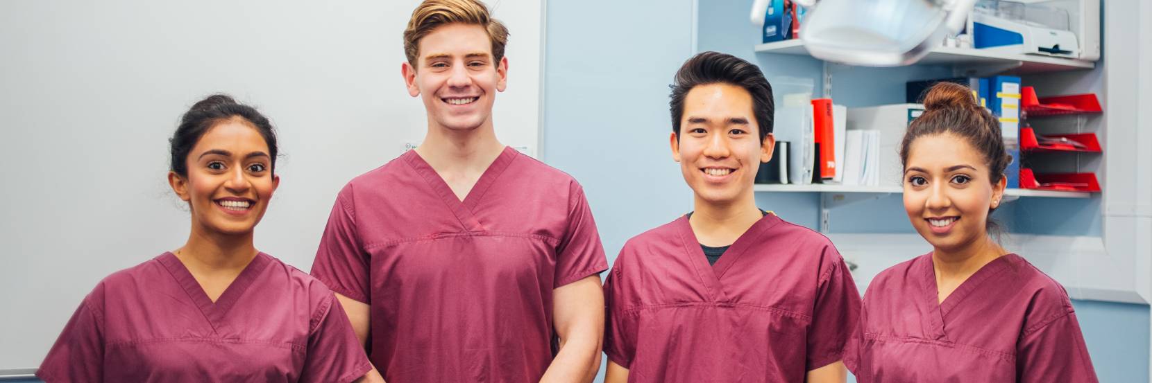 Smiling dental students, mix of male and female