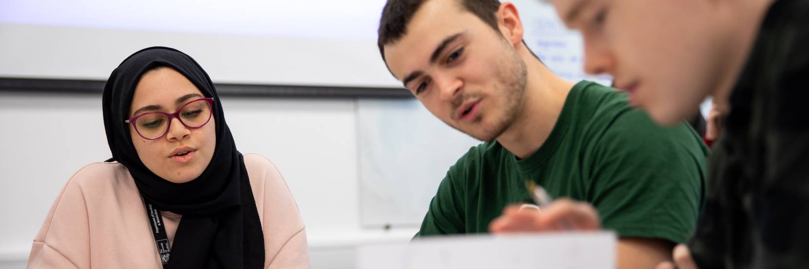 Students looking at document on table