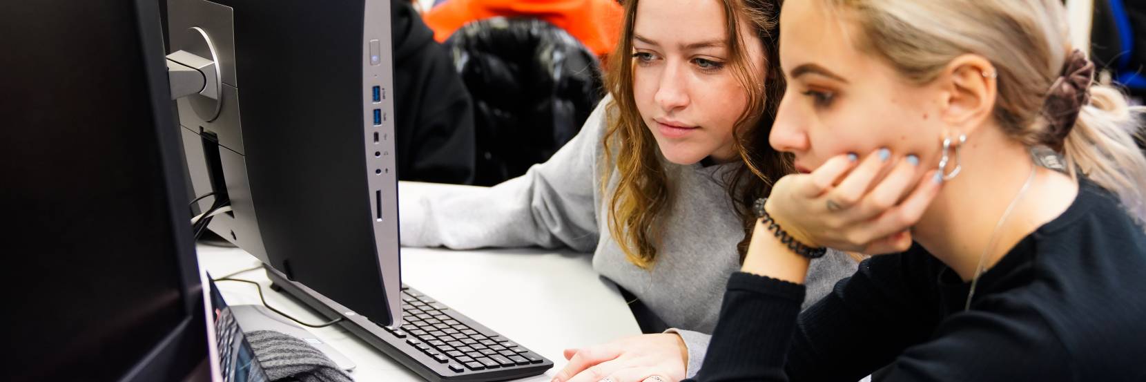 Two students looking at a computer