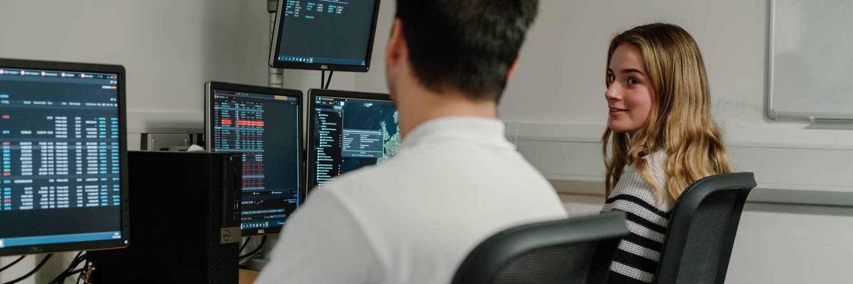 Two students working together in the Trading Room.