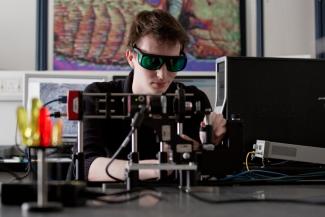 Postgraduate electronic and electrical engineering student with equipment