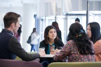 Image of postgraduate Information School students sitting around table