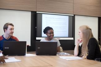 Image of group ofpostgraduate law students on laptops