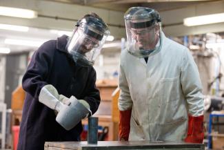 Image of two postgraduate materials science and engineering students with masks and equipment