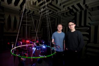 Image of Ruiqi Pan and Andrew Davies, postgraduate Mechanical Engineering students standing next to equipment