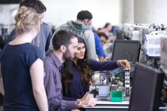 Two postgraduate ACSE students with equipment