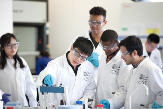 Group of Chemical and Biological Engineering postgraduates doing an experiment