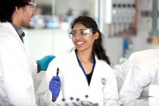 Chemical and Biological Engineering postgraduate in lab wearing goggles