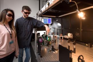 Chemistry postgraduate Liam Smith with a colleague in lab