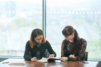 Two Education postgraduates at table