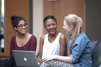 Three postgraduates with a laptop