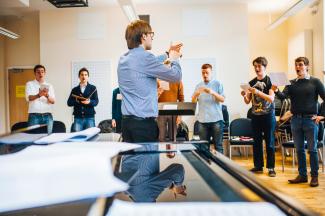 A group of postgraduates rehearsing