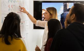 Sustainable architecture studies students discuss project with board