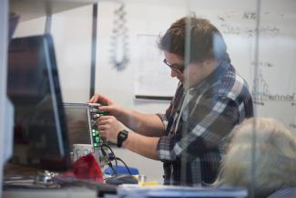 Particle Physics postgraduate using equipment