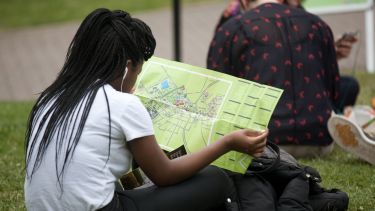 Prospective student sat outside on an open day