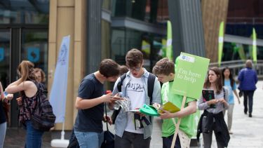 Visitors to an open day talk to current students
