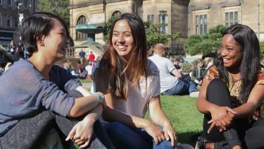 Students sitting in Peace Gardens by Town Hall