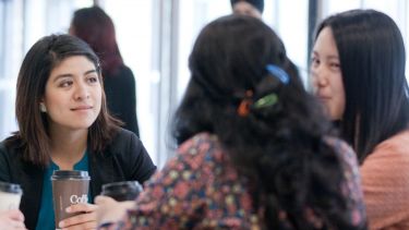 Image of postgraduate Information School students sitting around table