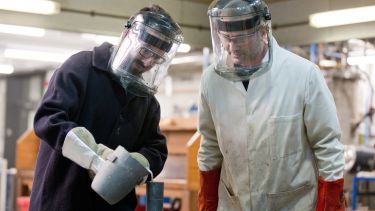 Image of two postgraduate materials science and engineering students with masks and equipment