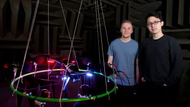 Image of Ruiqi Pan and Andrew Davies, postgraduate Mechanical Engineering students standing next to equipment