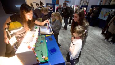 Postgraduate science communication student, Marlja Popova showing exhibit to child
