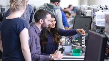 Two postgraduate ACSE students with equipment