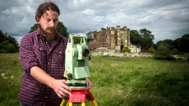 Medieval archaeology postgraduate with castle in the background