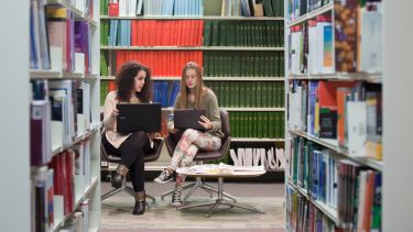 Students in library with laptop