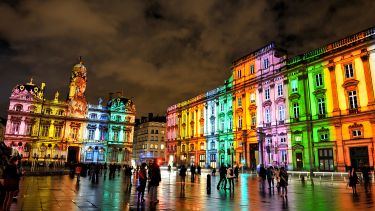 Buildings in Lyon lit with rainbow lighting