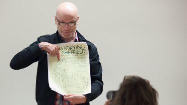 An English professor is photographed at a storytelling session.