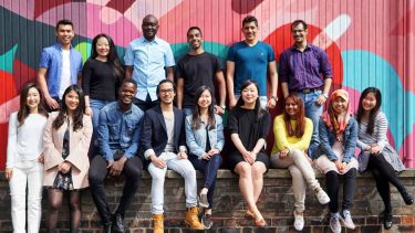 Large group of international students smiling at camera