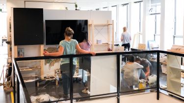 Students setting up summer exhibition
