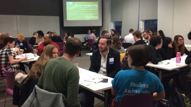 Students and alumni speaking in groups at a speed networking event in the department of politics
