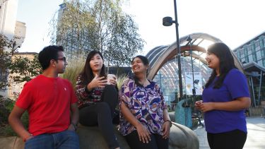 International students drink coffee at the Winter Gardens.