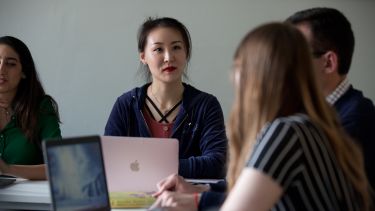 Photo of student in classroom using laptop