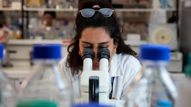 Student with microscope in the lab