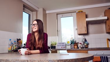 A student sat in their kitchen 