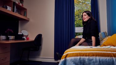 Student sat in an en-suite bedroom 