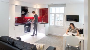 Studio 300 interior with two students cooking