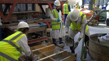 A group of civil engineering students casting concrete